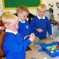 Children cutting shapes from playdough